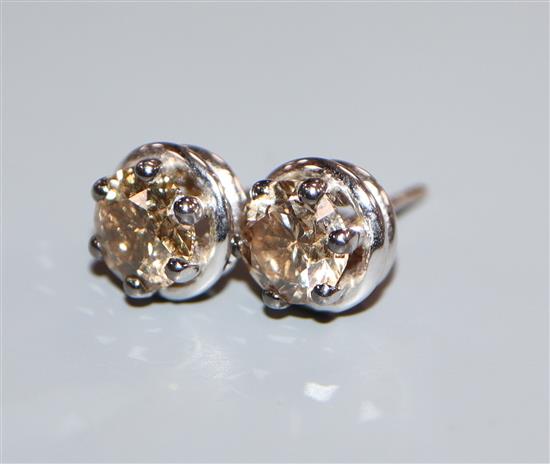 A pair of fancy yellow diamond and 18ct white gold ear studs, (the brilliant-cut diamonds approximately 1.0ct each).